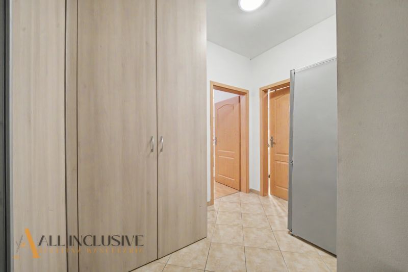 Hallway of a 1-room apartment with storage space and doors to other rooms.