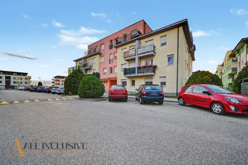 Apartment building on Platan Street in Šamorín with parking in front of the building.