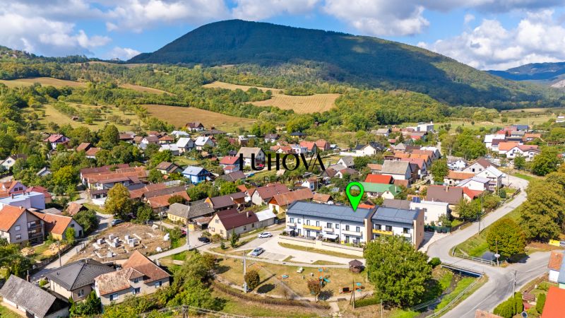 Aerial view of the village Mikušovce with beautiful nature and a view of a 3-room apartment.