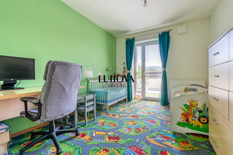 A children's room in a 3-room apartment with bright colors and a playful carpet with motifs.