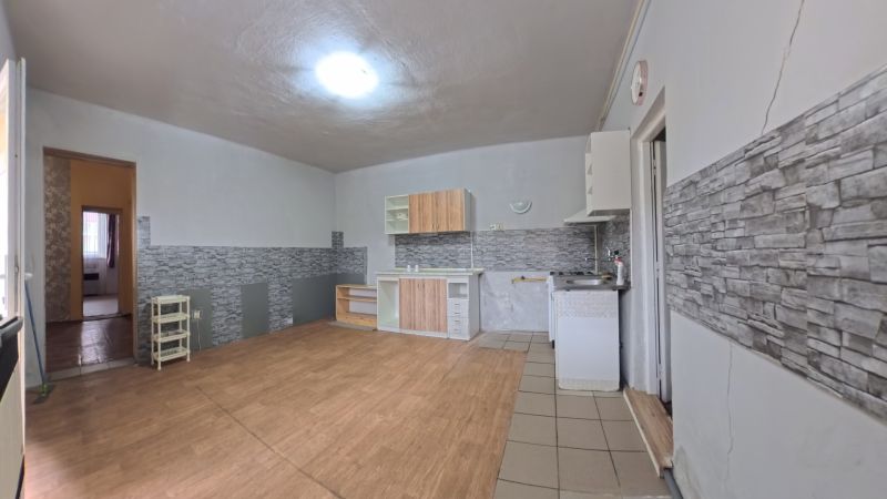 Interior of a family house with a kitchen unit and a wooden decor floor.