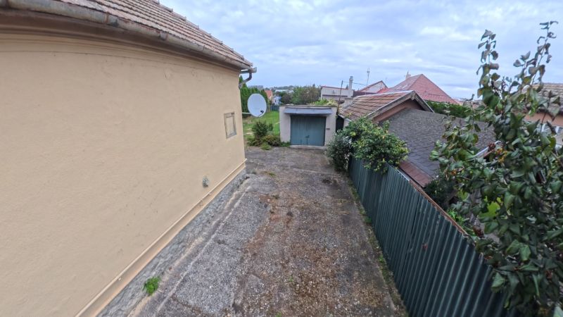Family house on Jesenského Street in Levice, concrete area and roofs of other houses.