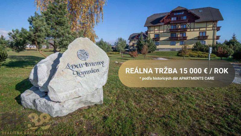 Veľká Lomnica: Apartments, greenery, buildings in the background, inscription on the rock.