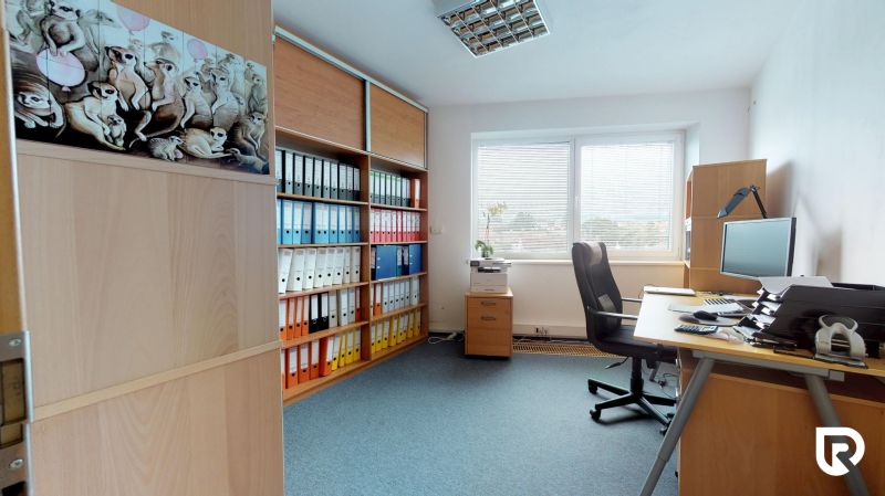Offices with wooden decor, shelves with registries, and a view from the window.
