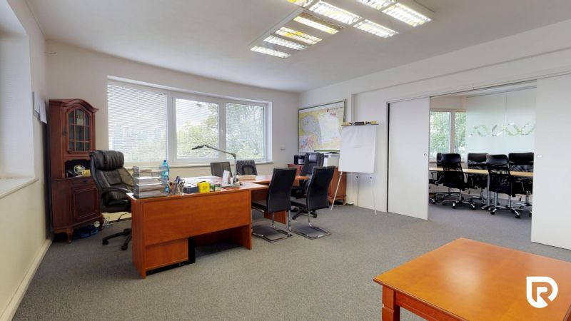 Offices with carpeted floors and wood-decor furniture, separated by sliding doors.