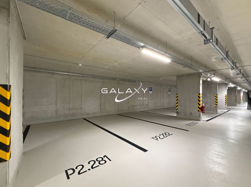 Parking spaces in indoor garages with numbering on the concrete floor.