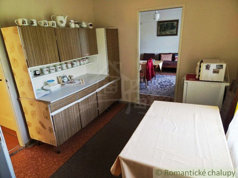 A kitchen in a family house with a classic cabinet and table, simple design.