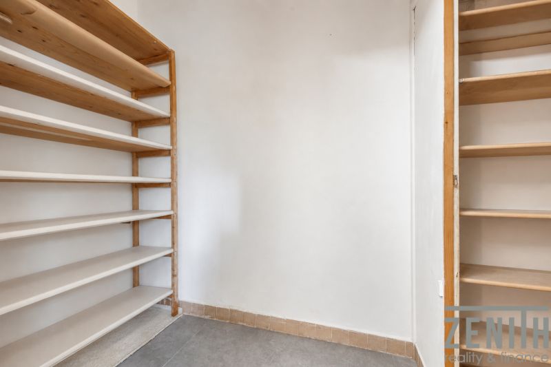 There is a storage space with shelves and tiles in the 4-room apartment.
