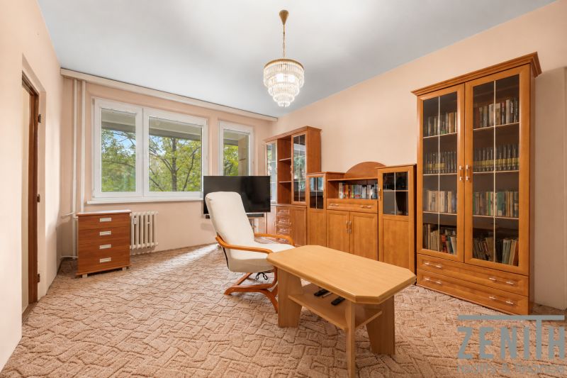 Living room in a 4-room apartment with wooden furniture and a coffee table.