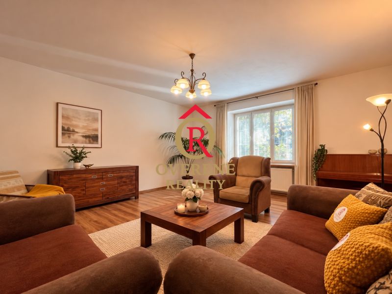 Living room in a two-room apartment with a wooden decor floor and comfortable furniture.