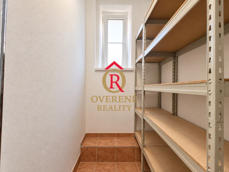 Storage space with shelves and tiles in a 2-room apartment.