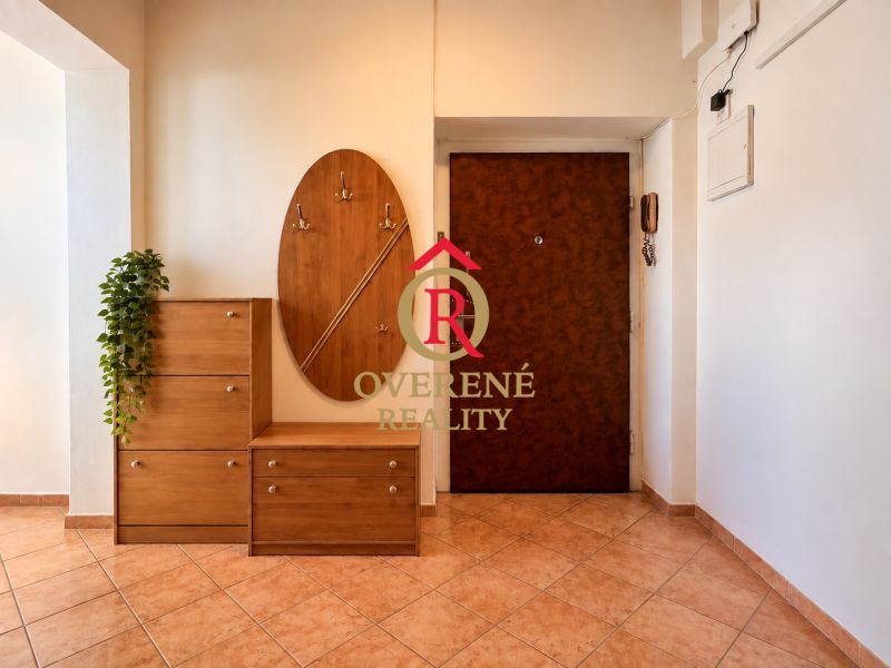 Entrance hall of a two-room apartment with wooden decor and practical furniture.