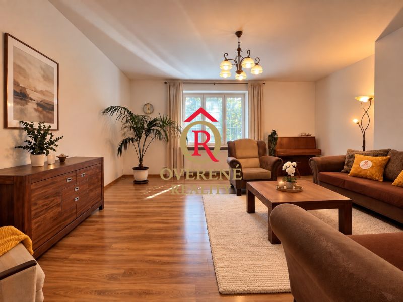 Living room in a two-room apartment with a wooden decor floor and comfortable seating.