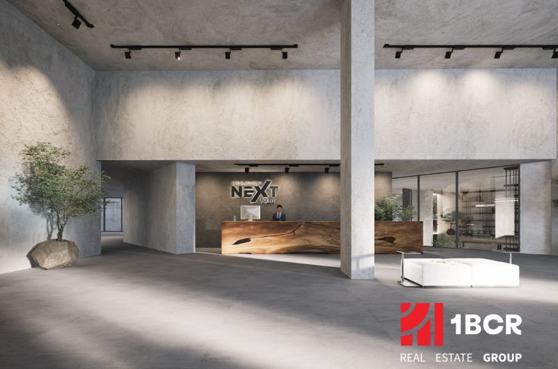 A spacious hall with a reception and minimalist furniture, part of an apartment construction.