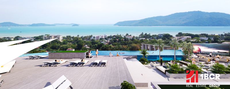 Apartment construction in Phuket with a pool and views of the sea and greenery.