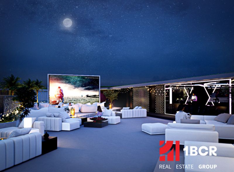 View of the exterior space of apartment construction in Phuket with an outdoor cinema.