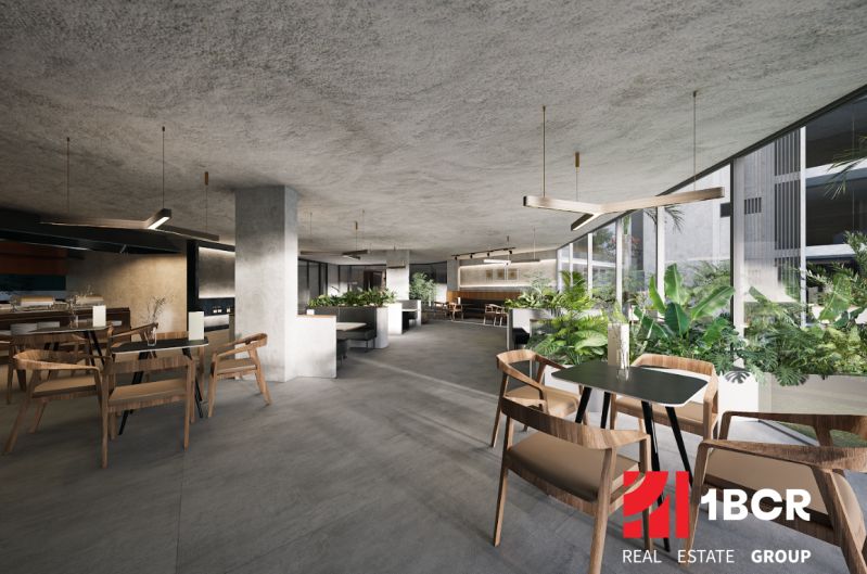 A bright bistro with tables and chairs, indoor plants, apartment construction.