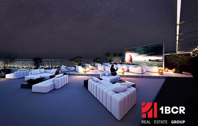 Rooftop terrace with seating and large screen, Apartment construction in Phuket.