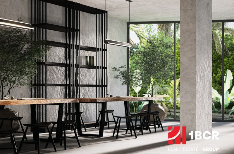 Interior with a long table, chairs, and large glass windows. Apartment construction.