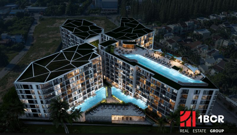 Apartment construction in Phuket: Modern complex with a pool in a nighttime setting.