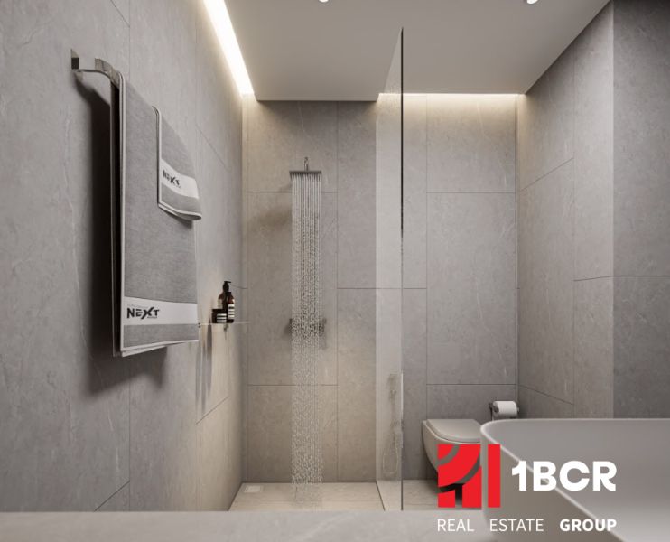 A minimalist bathroom in a 2-room apartment with an elegant bathtub and shower.