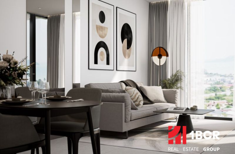 A bright interior of a 2-room apartment with a comfortable sofa and decorative paintings on the wall.
