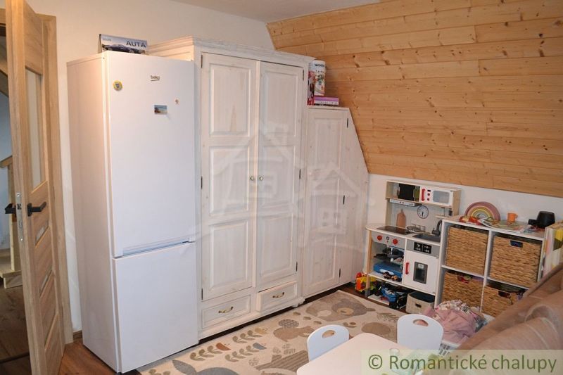 Children's corner in a cabin with wood-patterned flooring and storage space.
