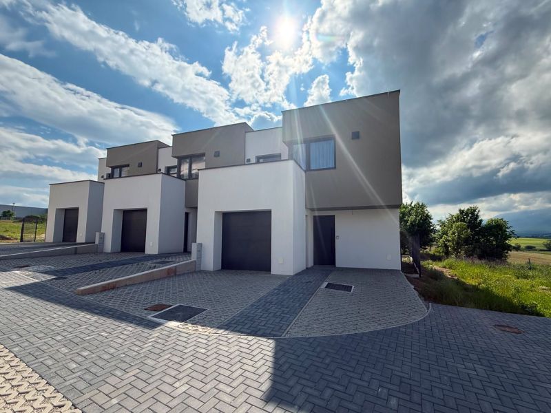 Poprad: Apartments and houses in Poprad in an environment with hills and open skies.