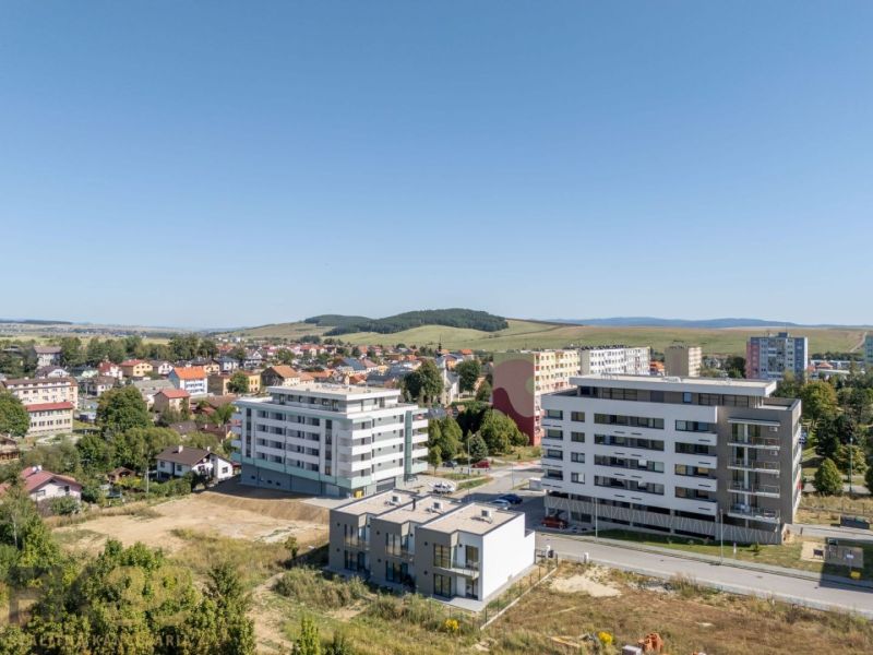 A family house in Poprad with a built-up area, garage, and paved driveway.