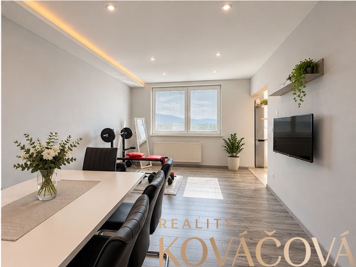 Spacious living area with dining table, wooden decor flooring, 4-room apartment.