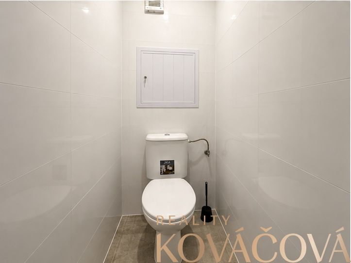 A bathroom with light walls and tiles in a 4-room apartment.