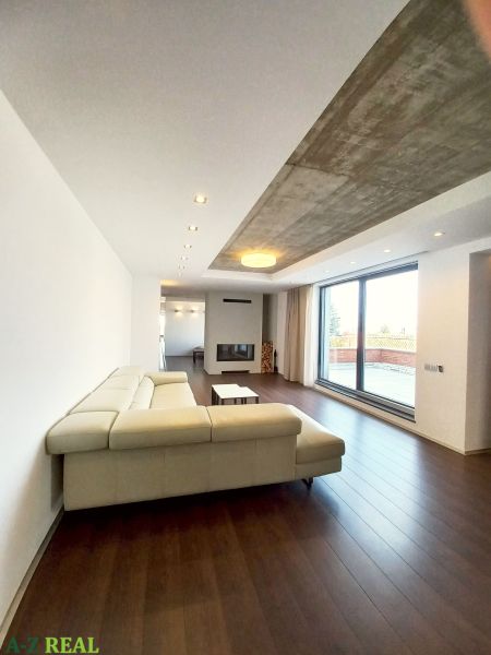 Living room with a fireplace, corner sofa, and wooden decor flooring in a 4-room apartment.