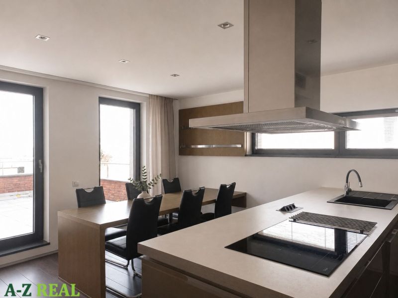 A kitchen in a 4-room apartment with a cooking island and a dining table.