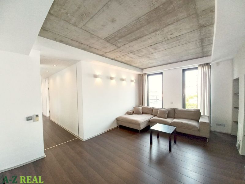 Living room in a 4-room apartment with a sofa, coffee table, and floor with a wooden decor.