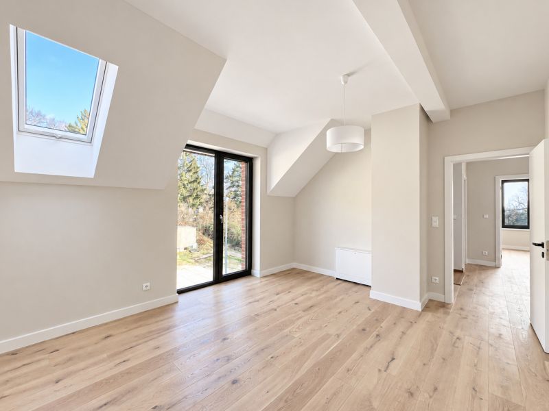 Interior of a family house with a wooden decor floor and glass doors.