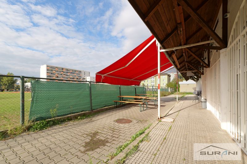 Terrace with a red awning at commercial premises on Korytnická in Bratislava - Podunajské Biskupice.