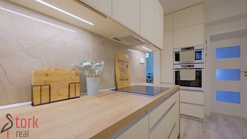 A kitchen in a 4-room apartment with an induction cooktop and ovens for baking.