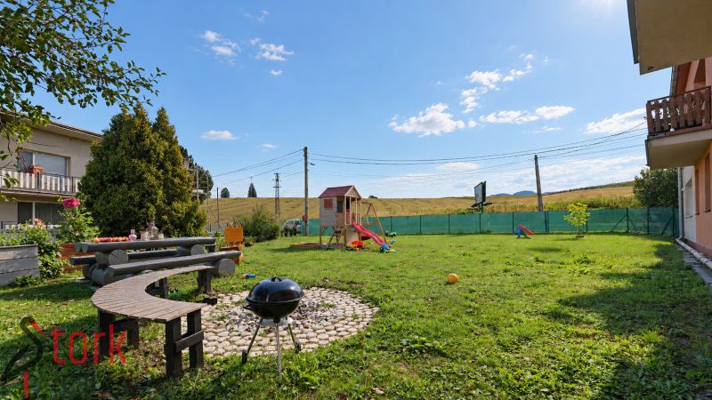 A garden with seating and a children's playground at a 4-room apartment on Bystrická Street in Rajec.