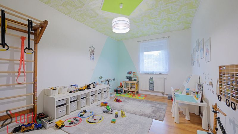 Children's room with toys and a wooden decor floor in a 4-room apartment.