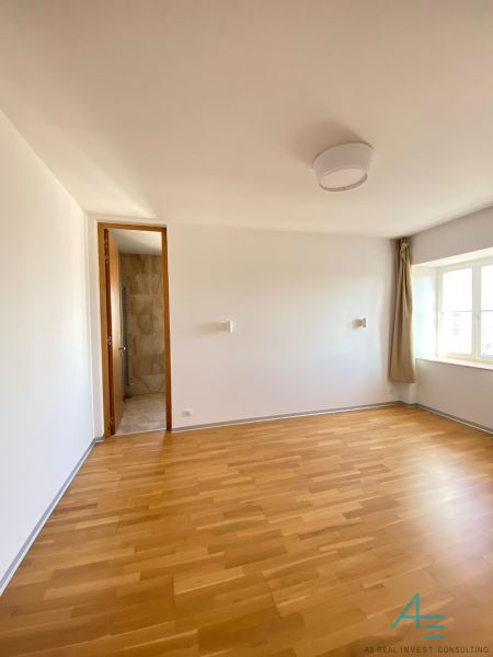 A room on Hlboká Street in a 3-room apartment with wooden flooring and a window.