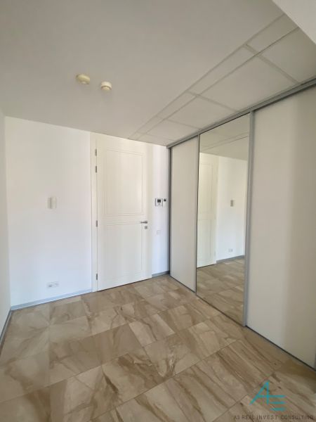 A hallway with tiles and a built-in wardrobe, suitable for a 3-room apartment on Hlboká Street.