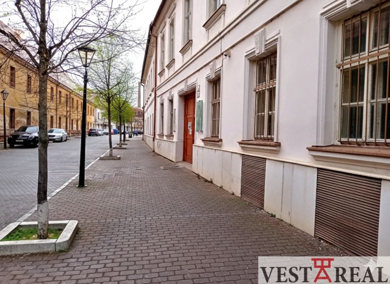 Františkánska Street in Trnava with historic buildings and trees near the offices.