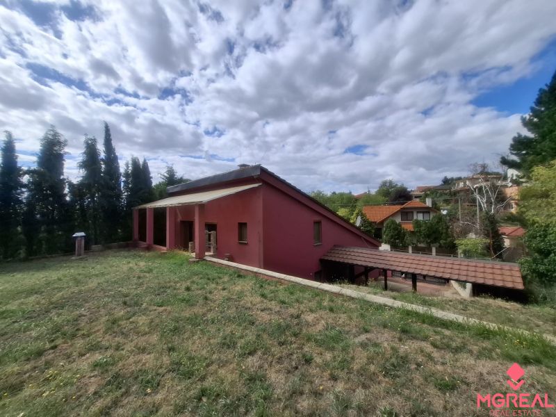 A family house on Chmeľová dolina in Zobor, surrounded by greenery and with a visible veranda.