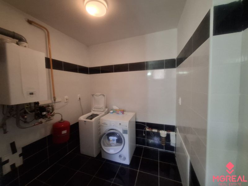 Technical room with a washing machine and boiler in a family house.