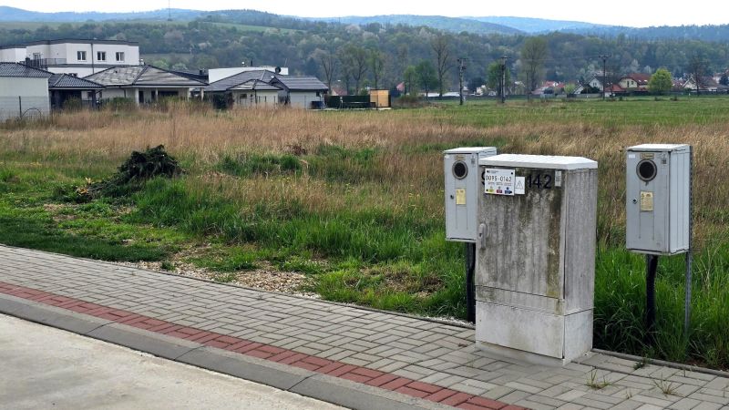 Flat residential plots in Banka with electrical distribution boxes in the foreground.