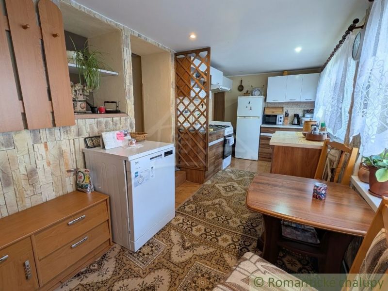 Kitchen in a family house with a dining table and kitchen counter.