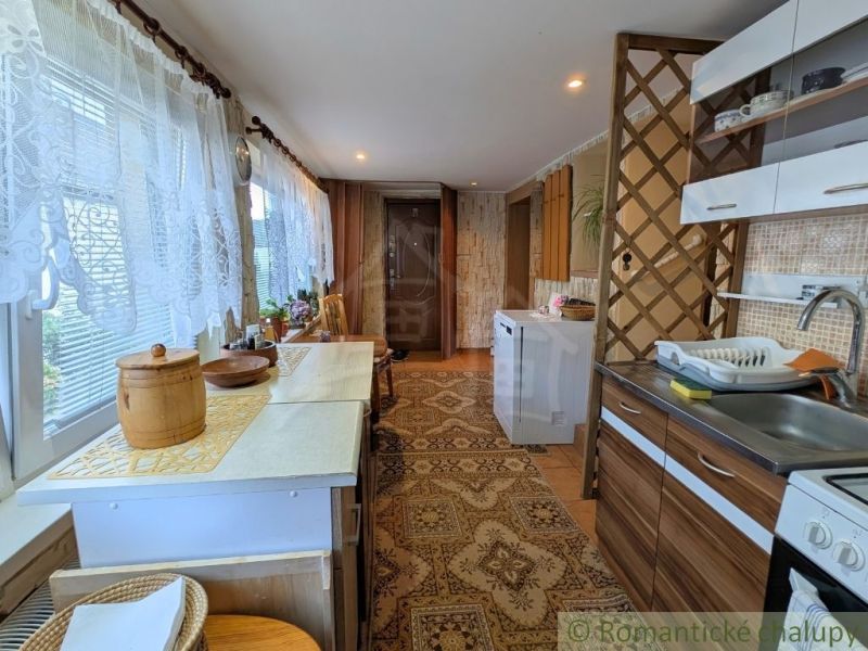 Rustic hallway with carpet and wooden decor in a family house.