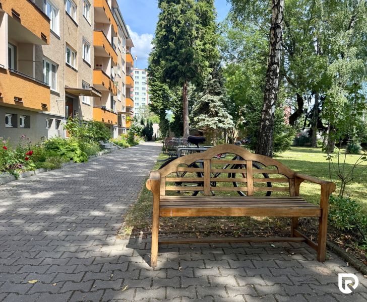 Exterior of a 3-room apartment on Pred poľom Street in Trenčín with garden seating.