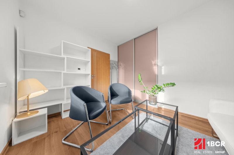3-room apartment with wooden decor, white furniture, and a glass table.