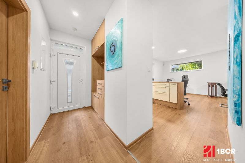A hallway in a 3-room apartment with a wooden decor floor and built-in furniture.